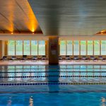 Modern indoor swimming pool with lanes and natural light